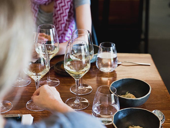 People drinking white wine with food